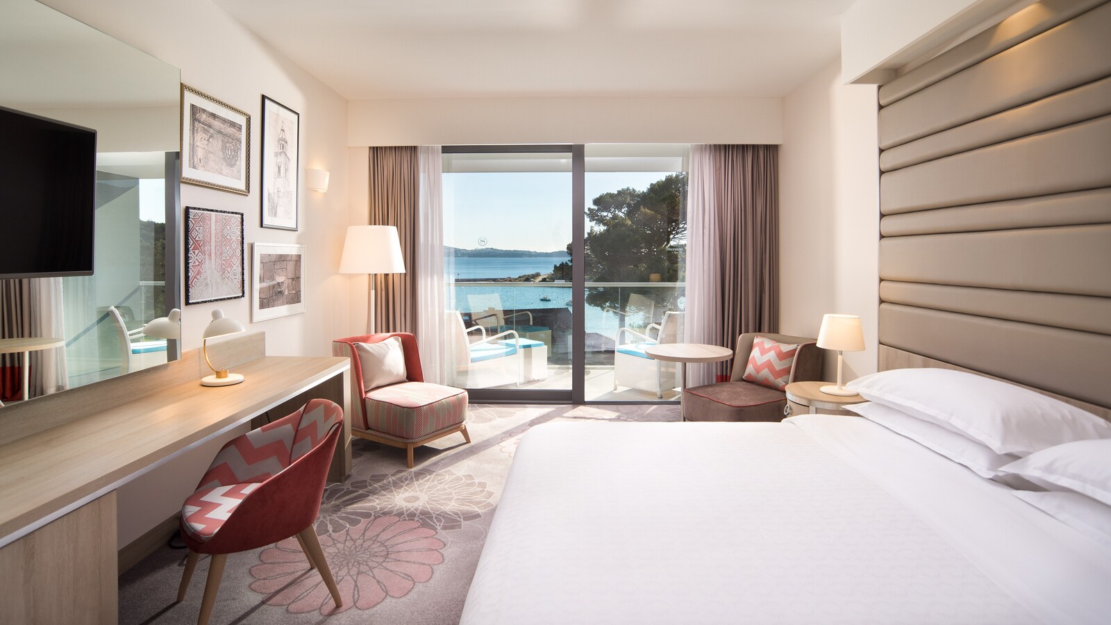Deluxe king room with a balcony and the sea beyond the glass doors