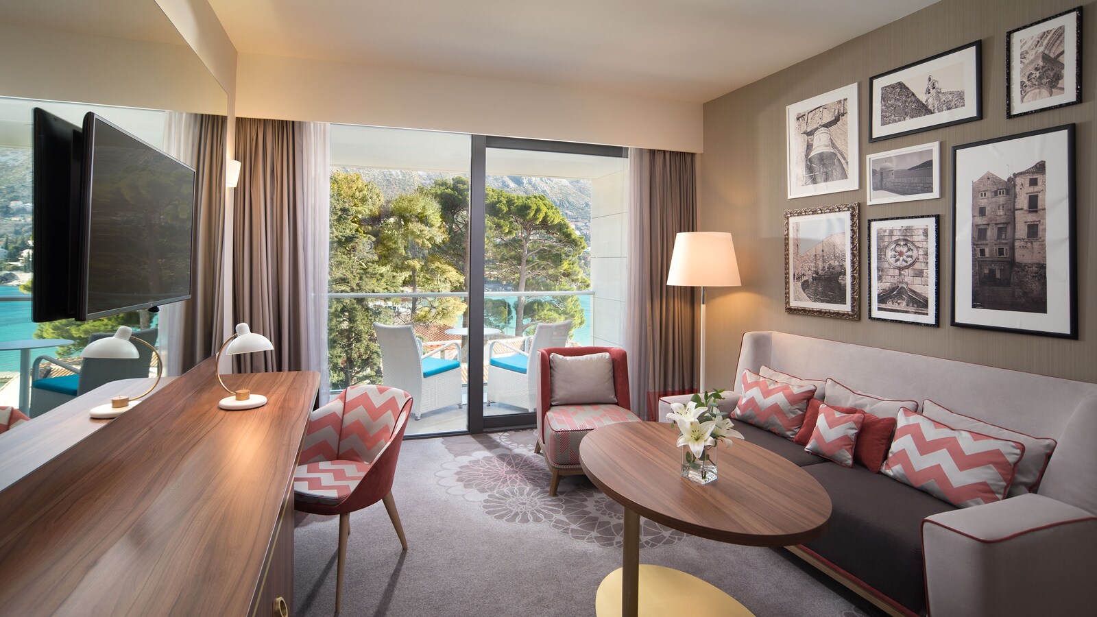 Executive Suite living room with a sofa, a desk, and a balcony toward the water