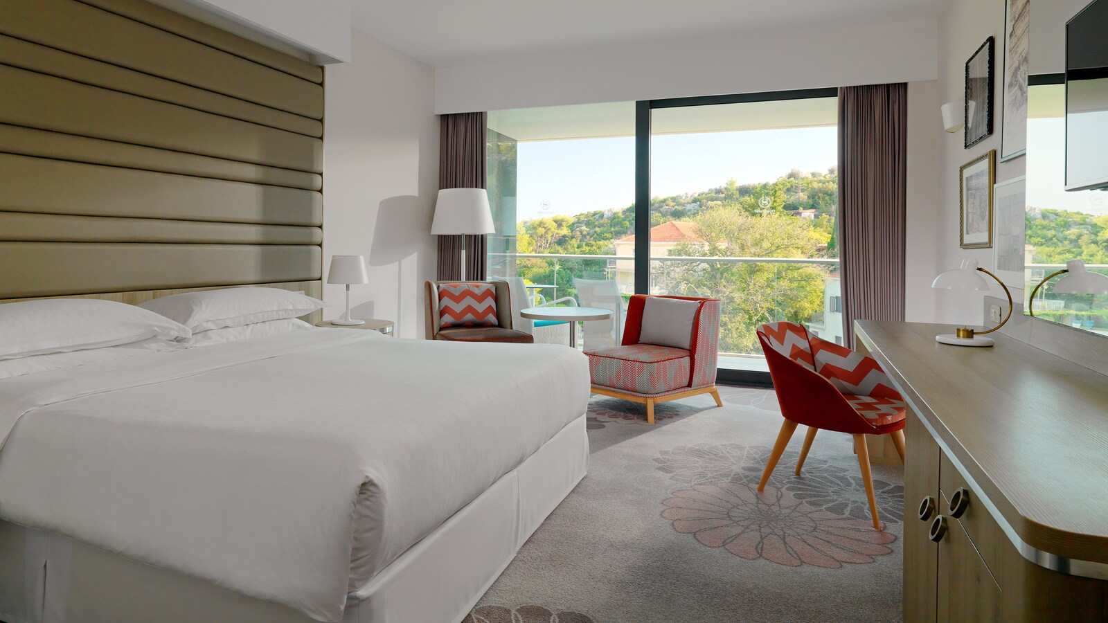 King Classic guest room with a balcony looking over trees and hillside houses