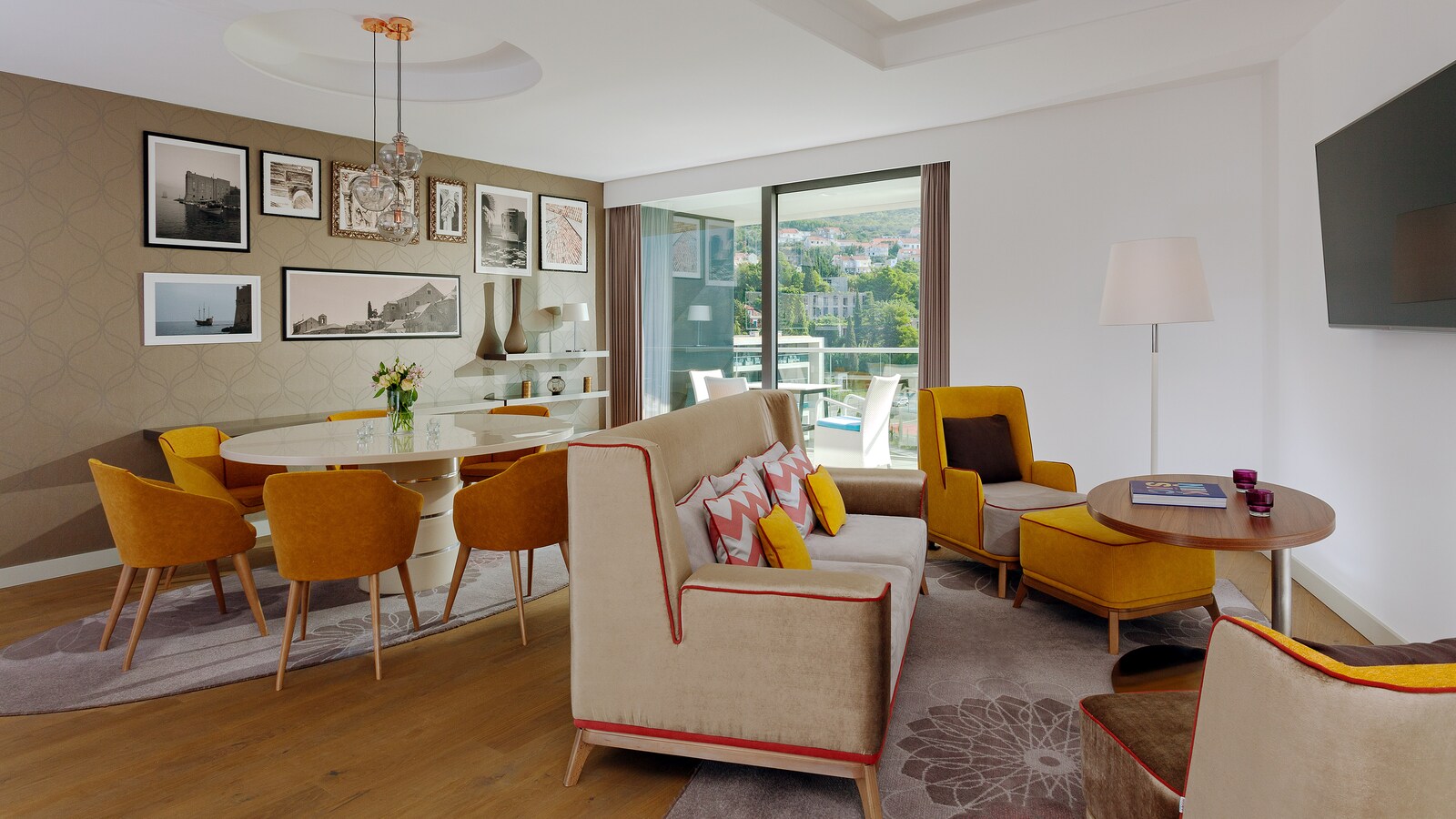 Presidential Suite living room with a dining table, a sofa, and a balcony over the town
