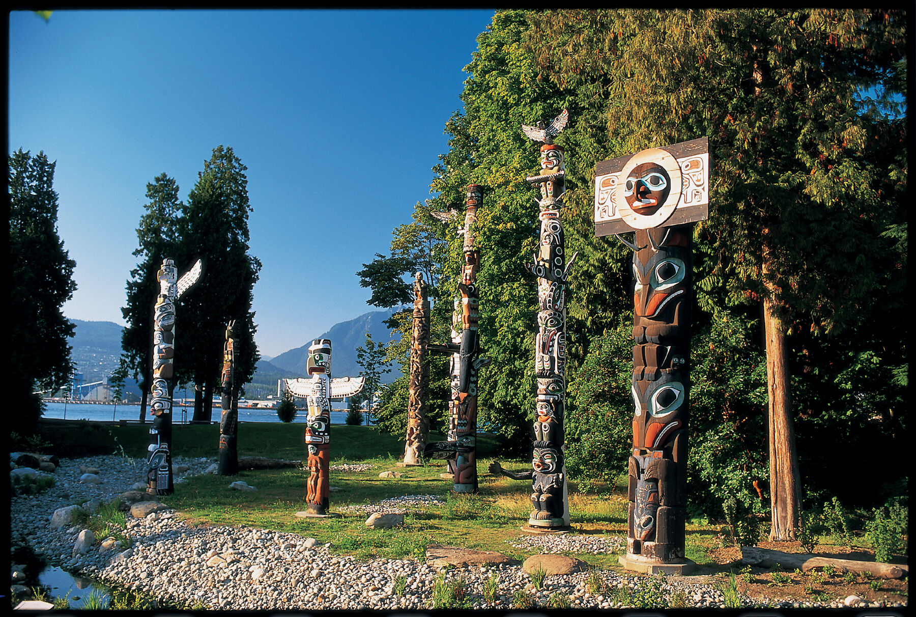 Totem poles beside the water in Stanley Park