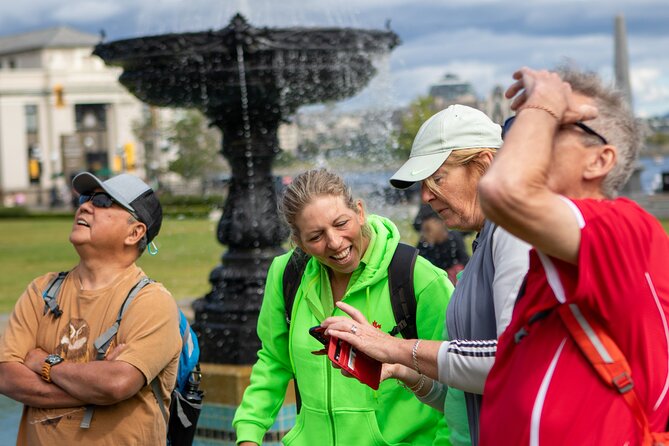 Visitors beside a fountain along Victoria's Inner Harbour