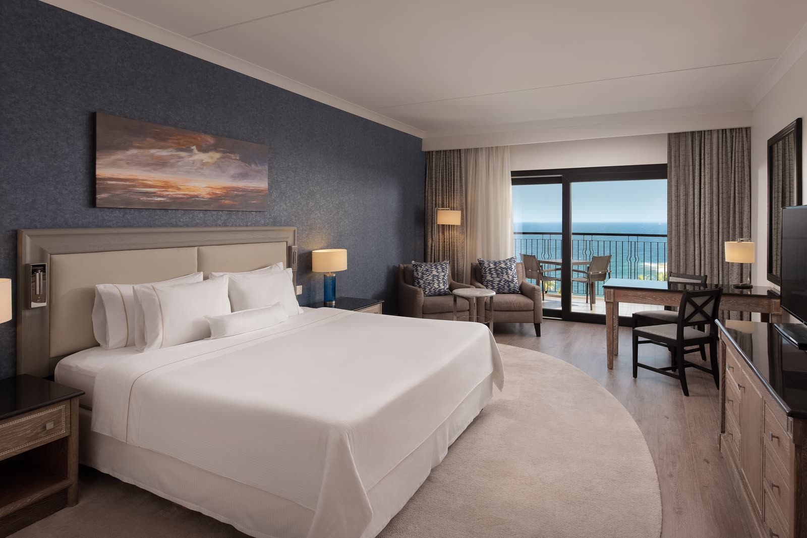 King guest room with a balcony and the sea beyond the railing