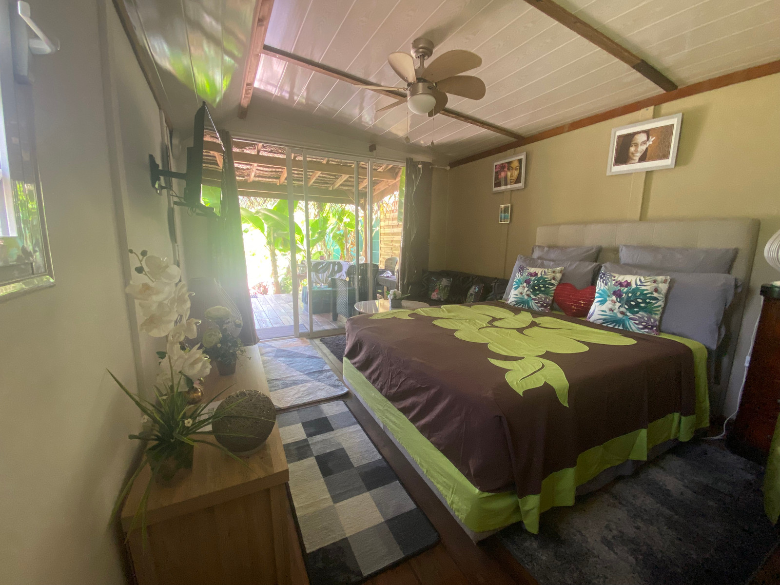 Fare Oaoa Haapiti Beachfront Bungalow bedroom opening to a private deck