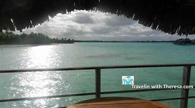 Beach View Overwater Villa balcony overlooking the lagoon and sandy beach shoreline