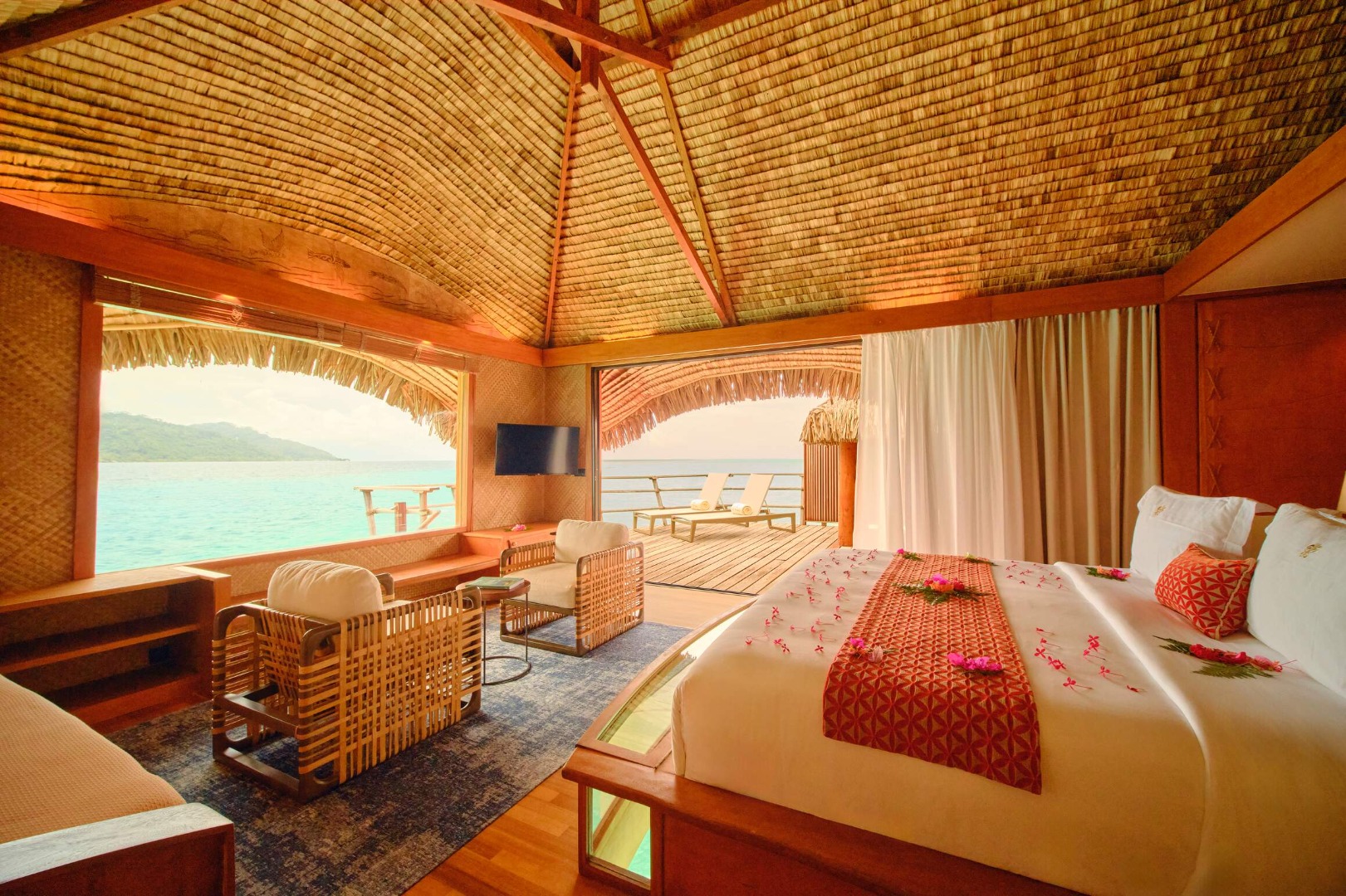 Le Taha'a Overwater Suite bedroom with king bed