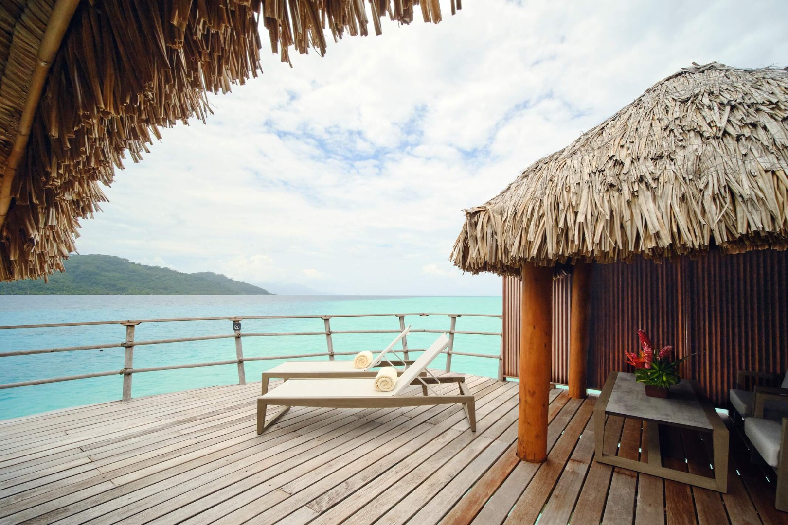 Le Taha'a Overwater Suite shaded deck lounge overlooking turquoise water