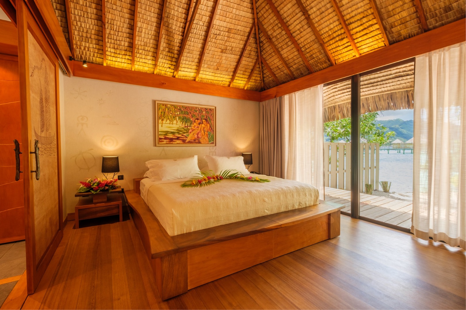 Le Taha'a Pool Beach Villa bedroom with thatched ceiling