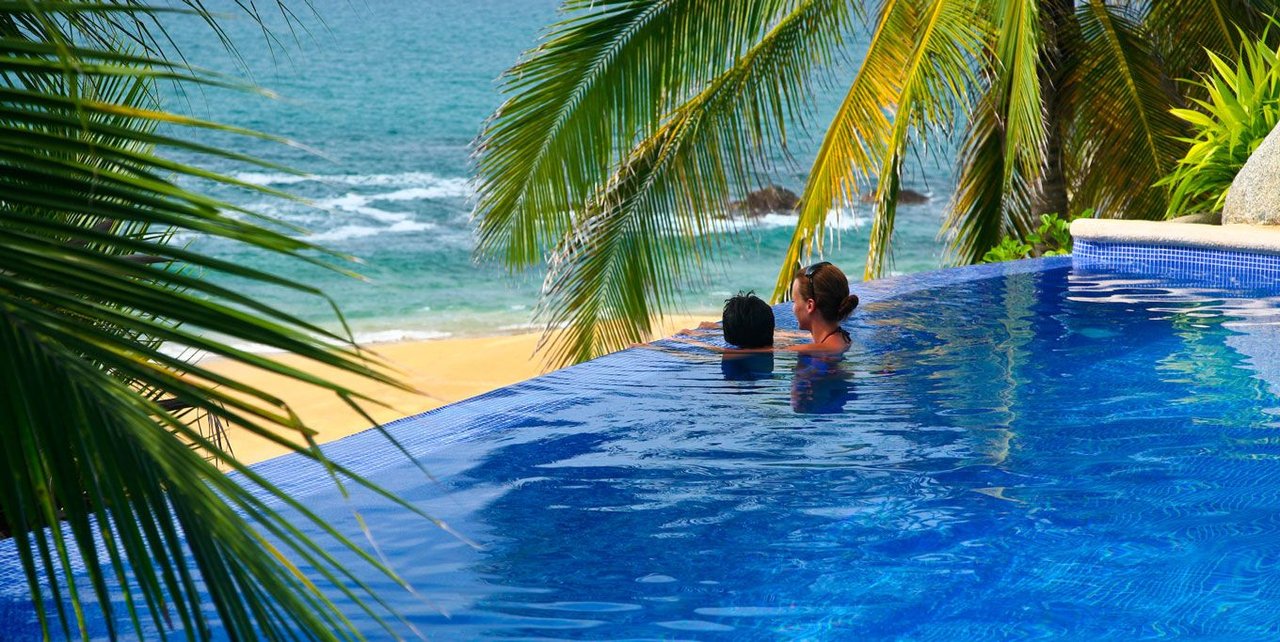 Guests relaxing in the Playa Escondida infinity pool