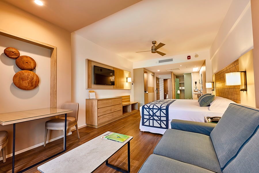 Junior Suite Partial Ocean View living area and king bed at RIU Palace Baja California