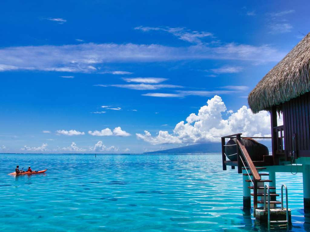 Private deck of a Sofitel Moorea overwater villa with ladder into the lagoon