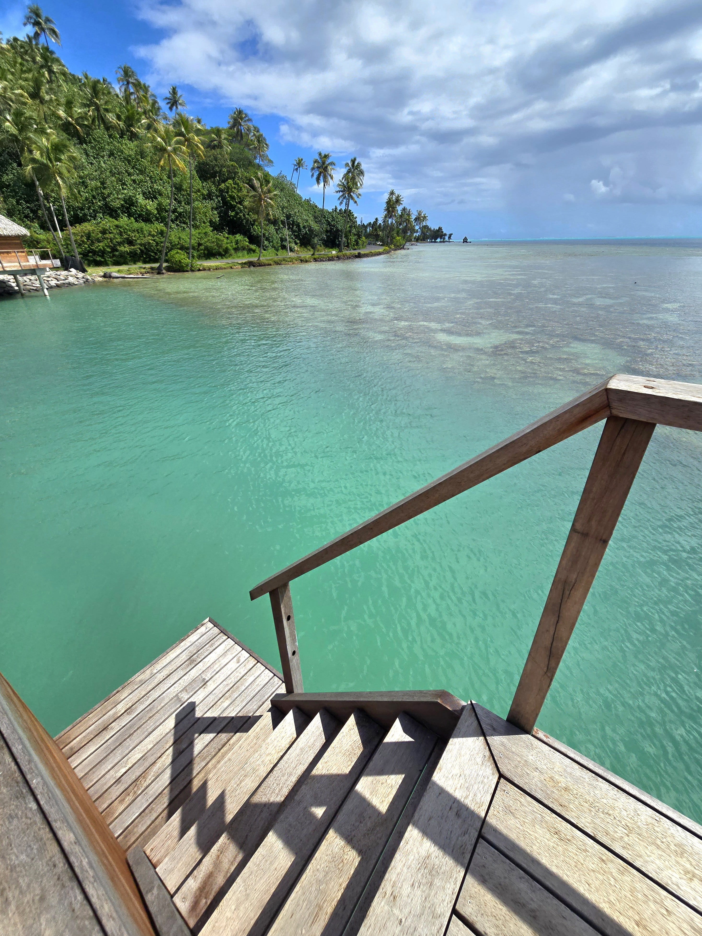 View from the bungalow steps over the clear lagoon at Bloody Mary's Hotel Bora Bora