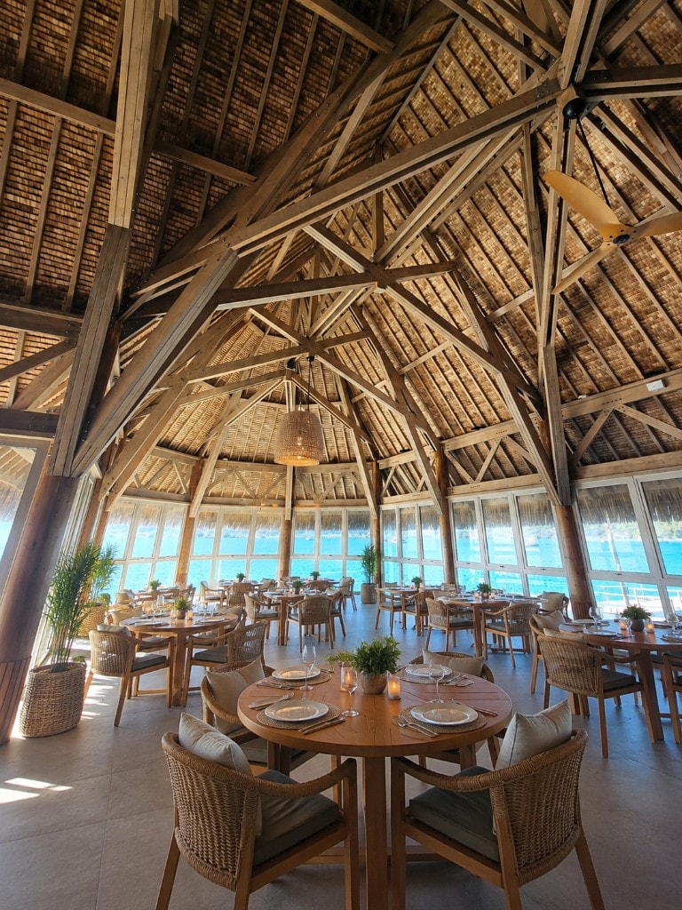 Povai Bay overwater dining pavilion with thatched roof above the Bora Bora lagoon