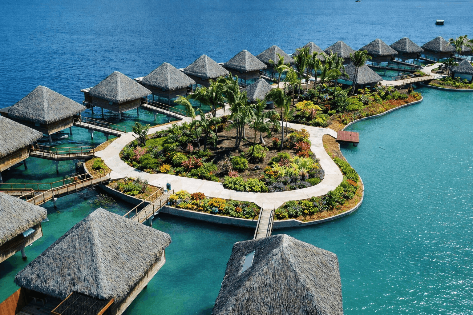Aerial view of Bloody Mary's Hotel Otemanu View Bungalows on stilts around a landscaped islet