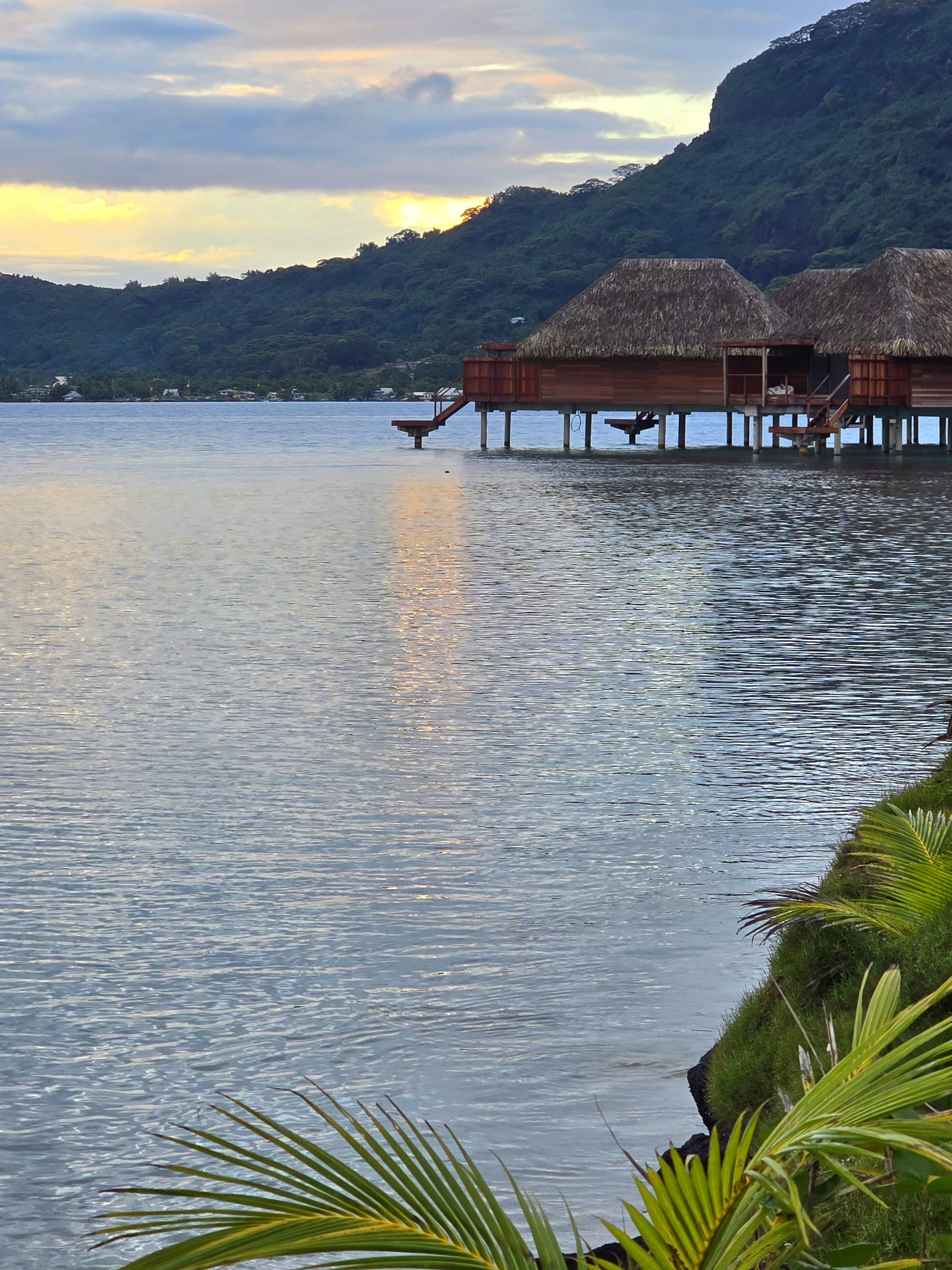 Bloody Mary's Hotel Sunset View Suites at golden hour with mountain backdrop and calm lagoon
