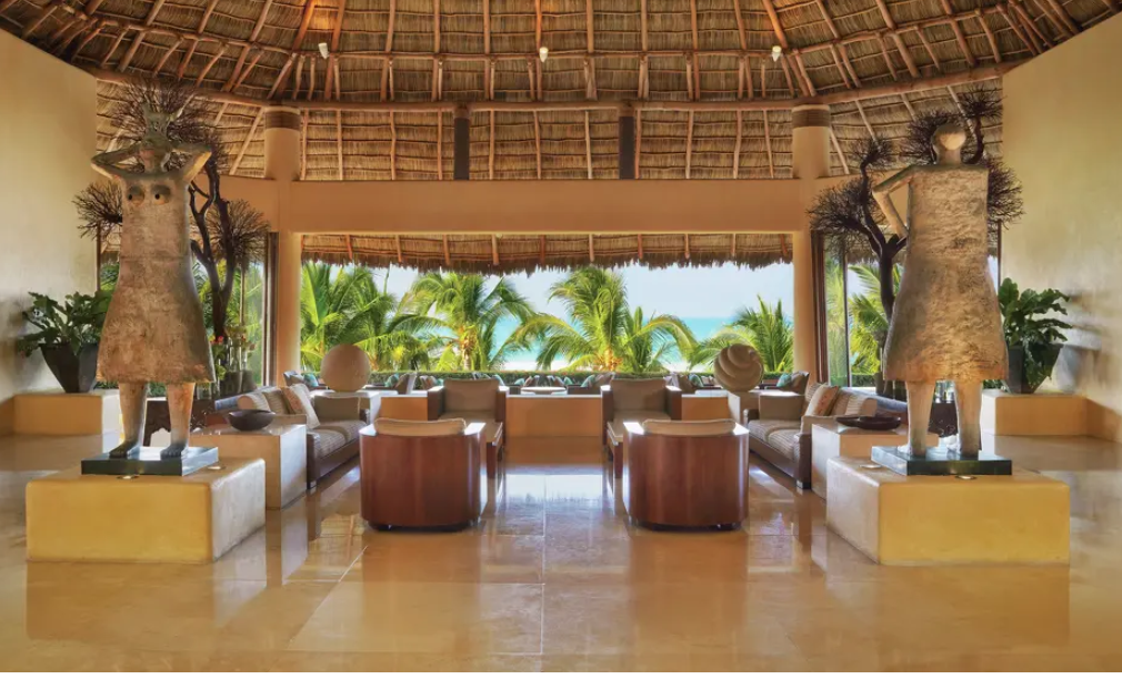Open-air lobby with thatched roof and ocean outlook at Four Seasons Resort Punta Mita