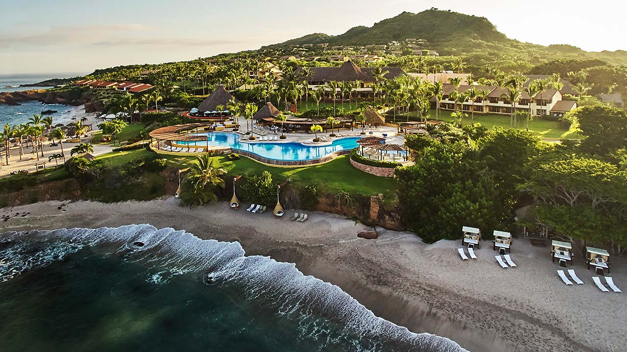 Four Seasons Resort Punta Mita aerial view of the beach, infinity pool, and hillside casitas