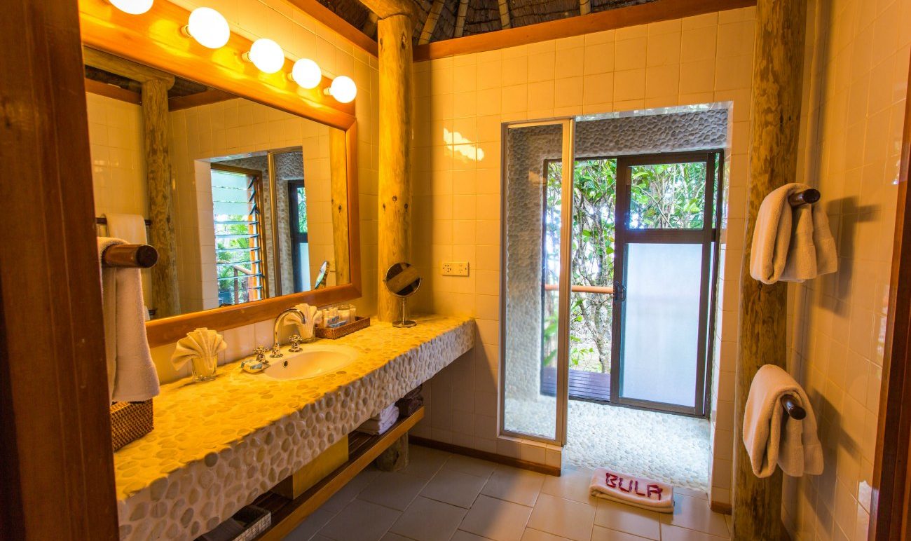 Namale Fiji Garden Tropical Bure bathroom with stone accents