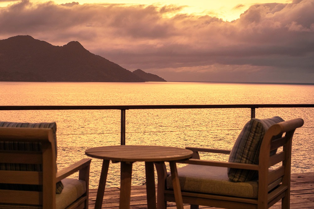Royal Davui Lagoon Plunge Pool Bungalow living room and deck at sunrise