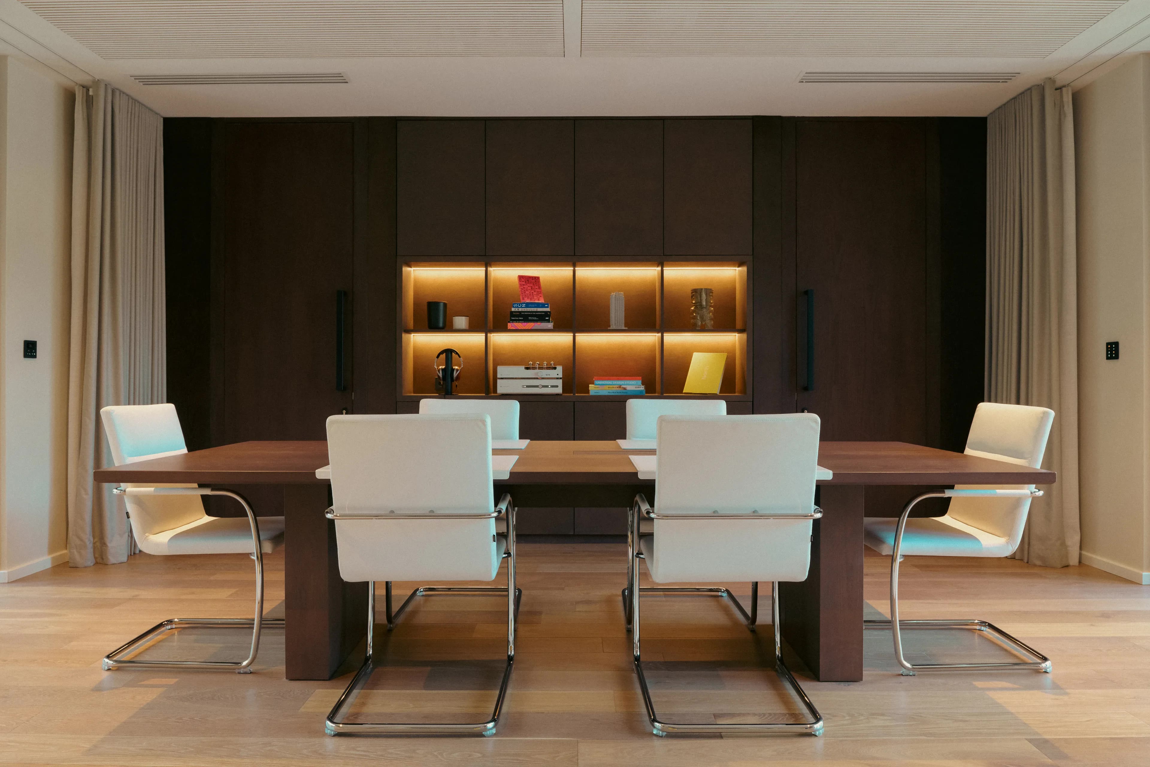 Villa Oro Paraoa Studio conference table and cabinetry wall