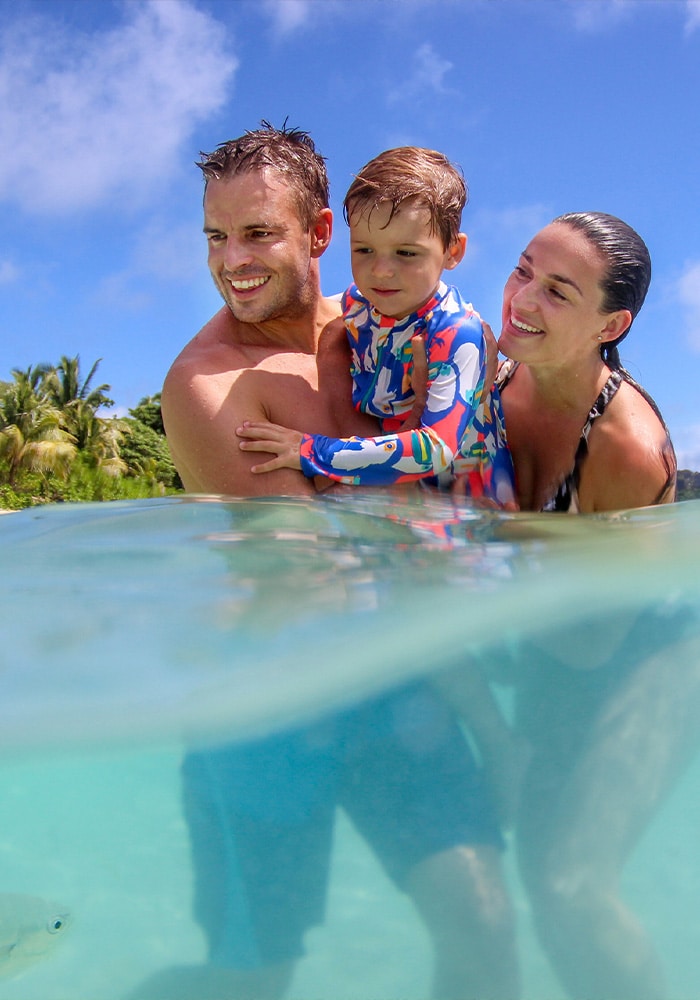 Family swimming offshore at Vomo Island Resort Fiji