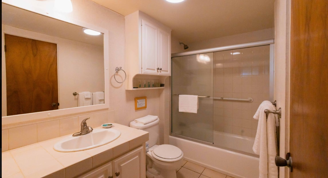 Suite bathroom with a tub and shower at Hanalei Colony Resort, Kauai