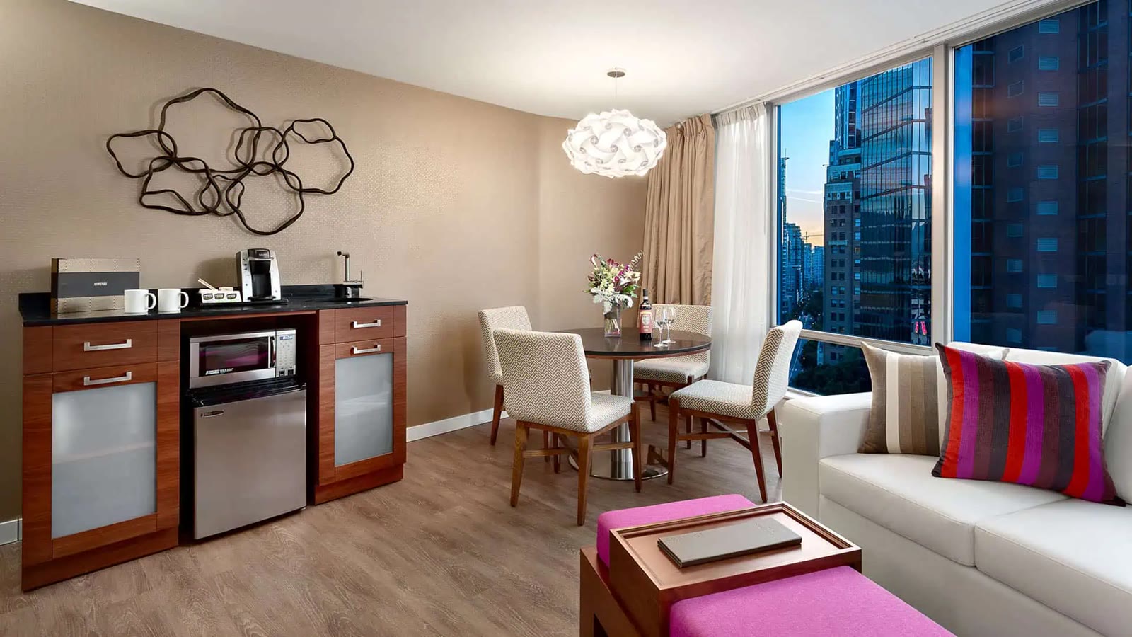 Living and dining area in the Deluxe King City View Suite at Auberge Vancouver Hotel