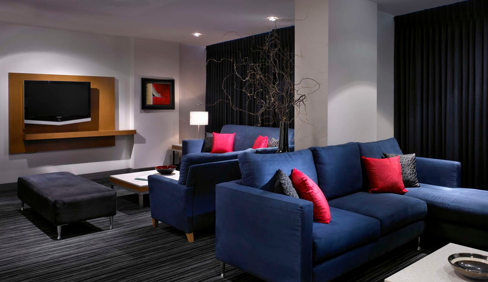 Suite living area at Hyatt Regency Vancouver with a sofa and city-view windows