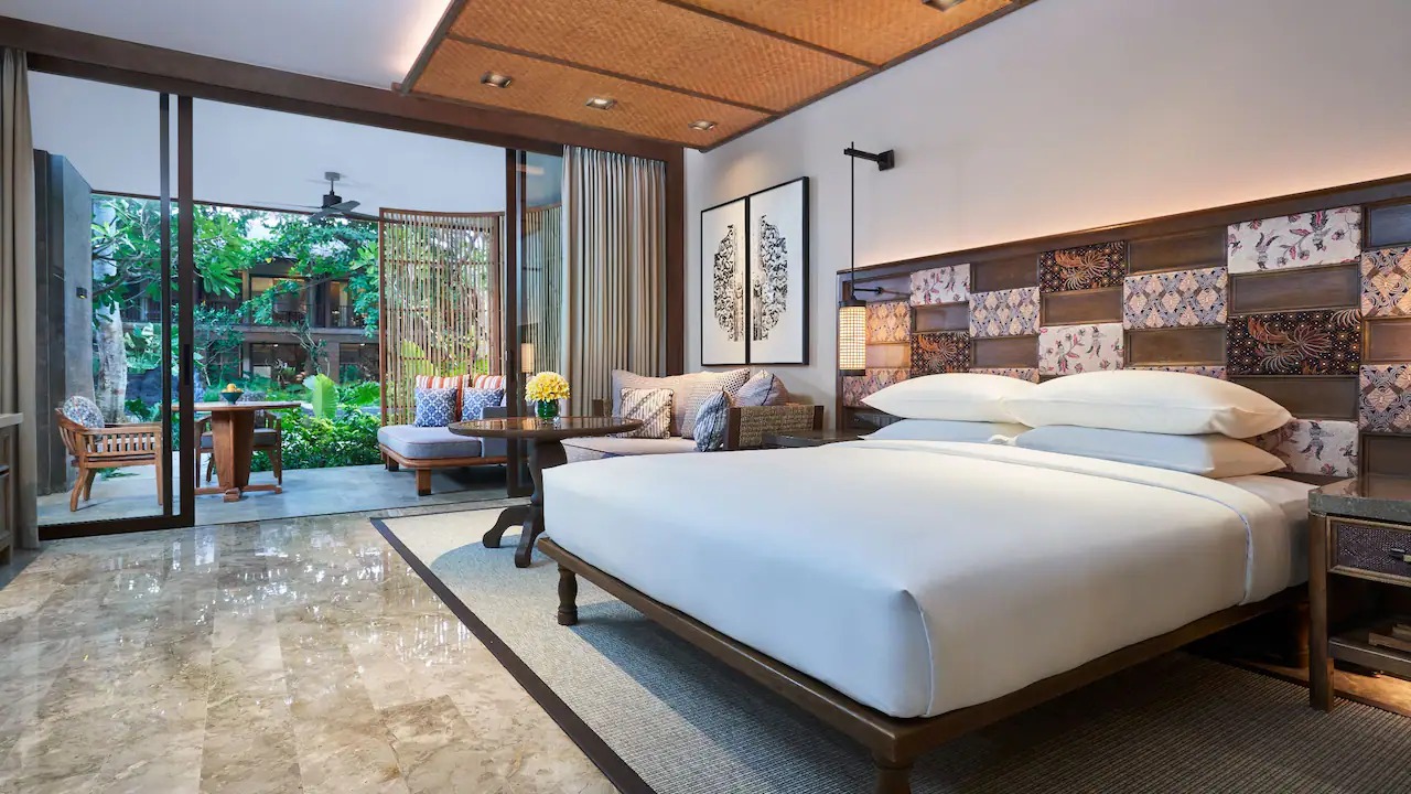 King bed and garden outlook in a Deluxe Room at Andaz Bali