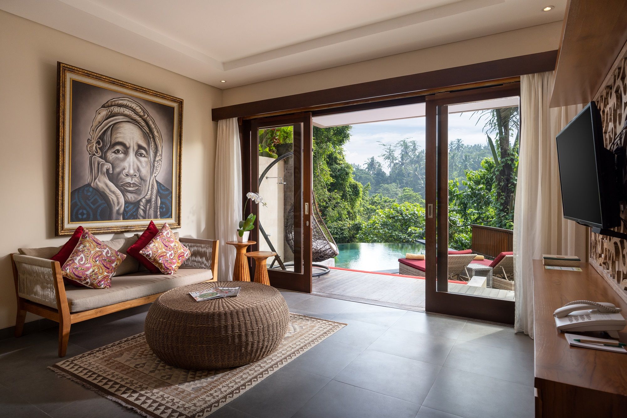Living room of the One-Bedroom Pool Villa with Hammock, looking out to the private pool at Jannata Ubud