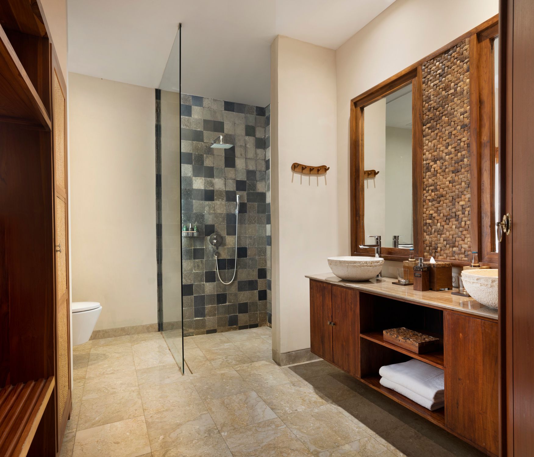 Walk-in rain shower and stone vanities in a Superior Room at Jannata Resort Ubud
