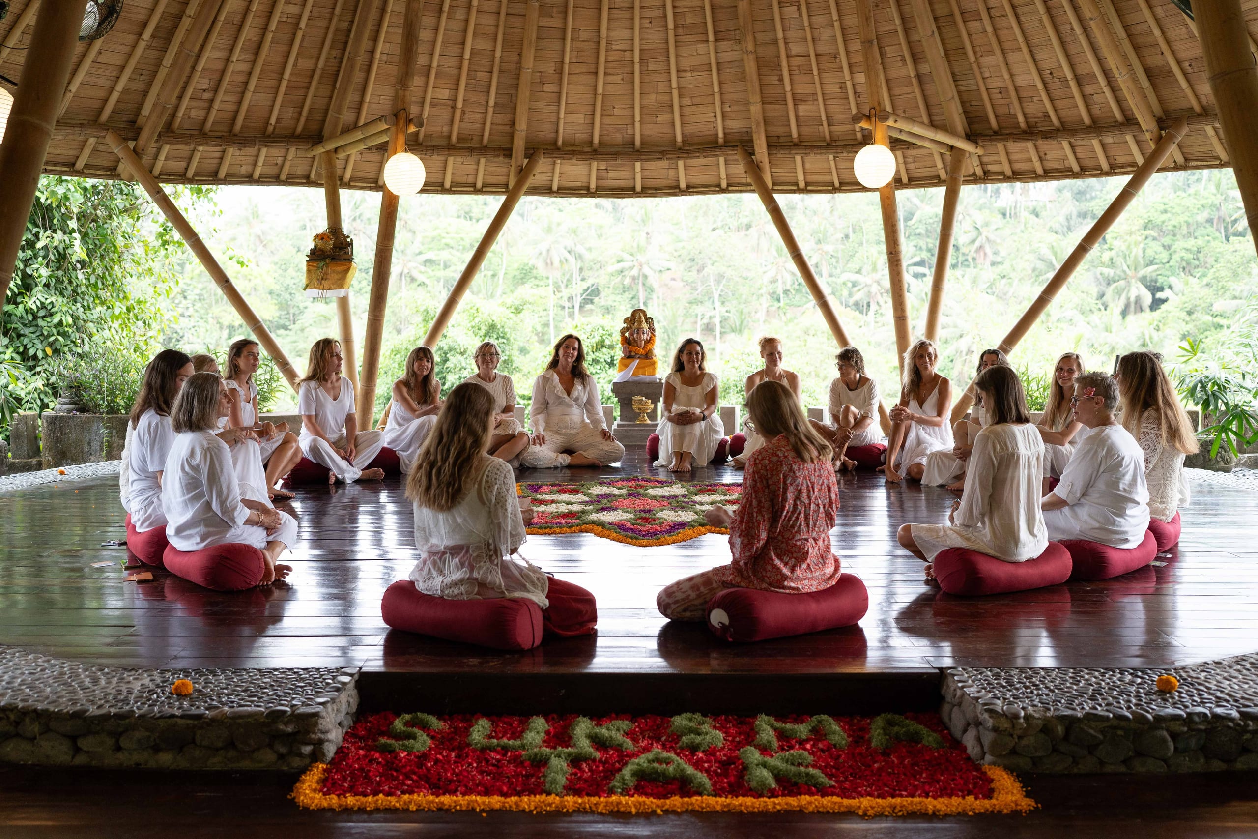 Yoga shala at Jannata Resort & Spa Ubud, with guests seated in a circle facing the jungle